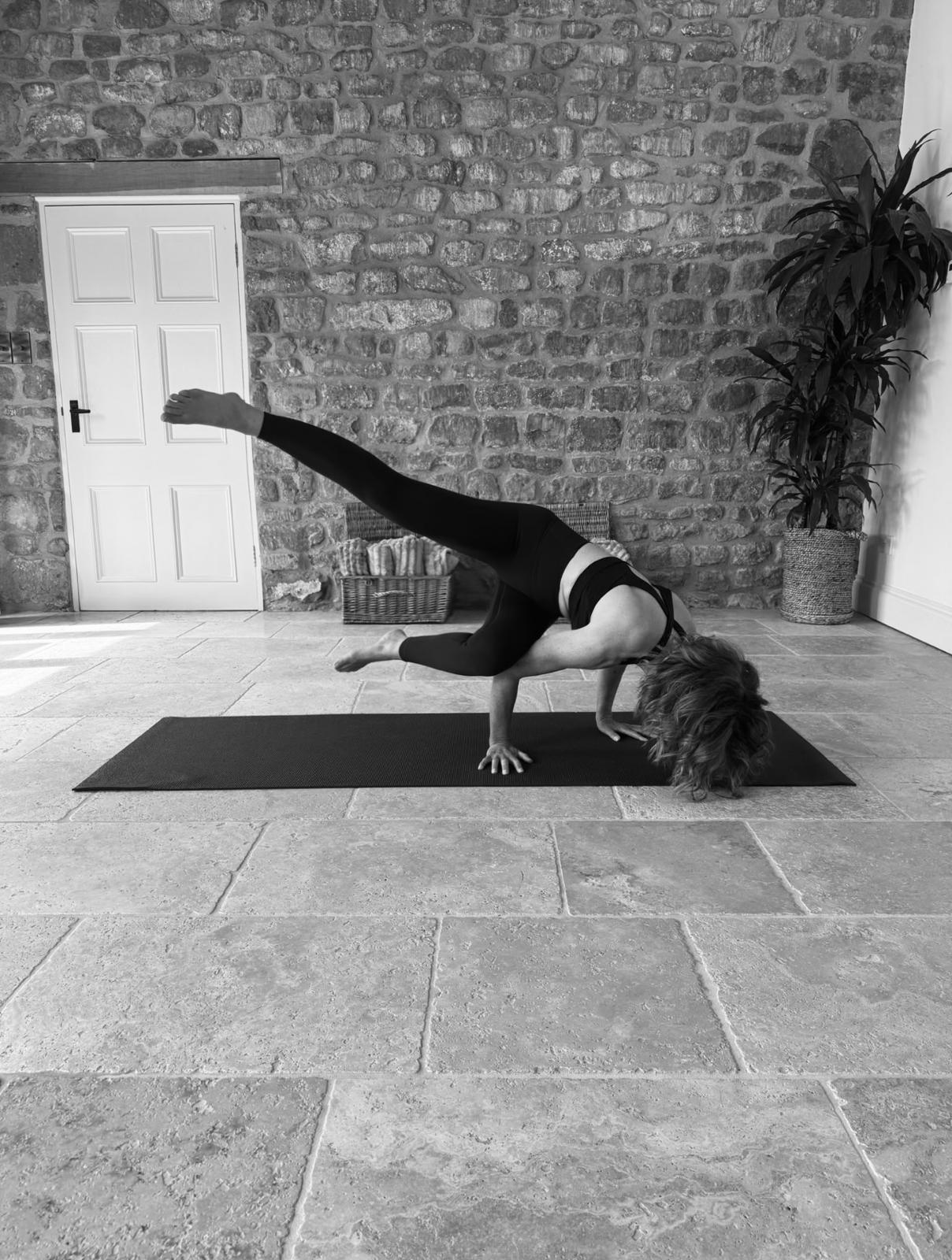 Crow pose in the light-filled studio